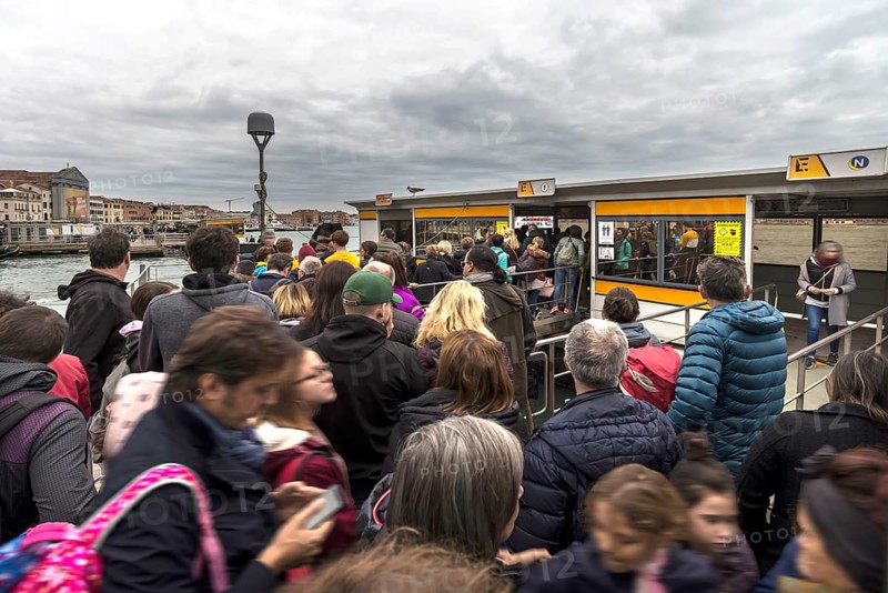 High season crowds at the vaporetto station, Venice, Veneto, Italy