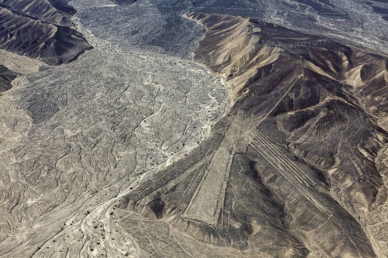 Desert mountain landscape with impressive Nazca lines from above in Peru, the geoglyphs and images in the desert near Nasca and Palpa in Peru
