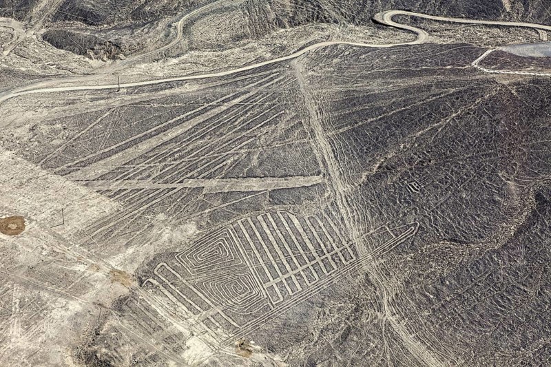 Aerial view of a desert region with numerous Nazca line patterns in Peru, the geoglyphs and images in the desert near Nasca and Palpa in Peru