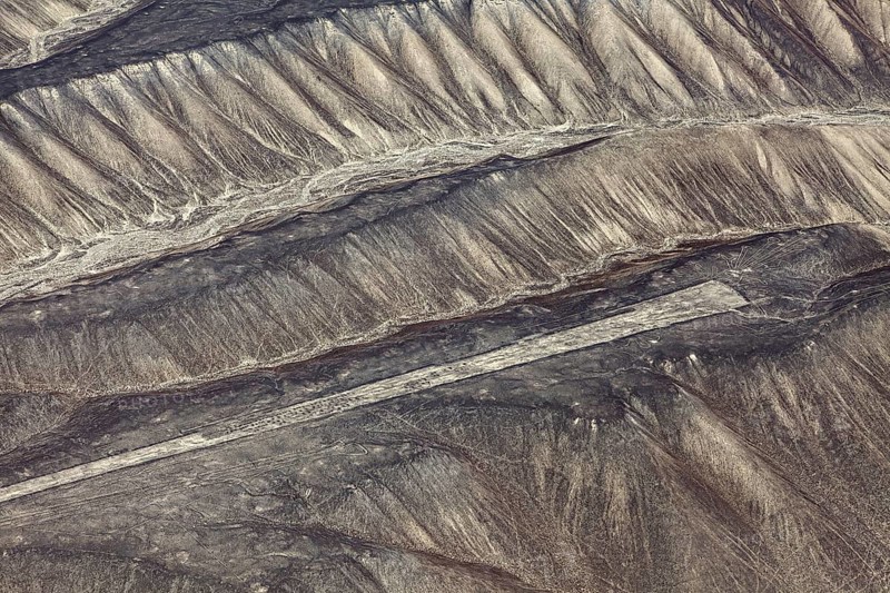 Aerial view of Nazca glyphs spanning sandy hills, the geoglyphs and paintings in the desert near Nasca and Palpa in Peru