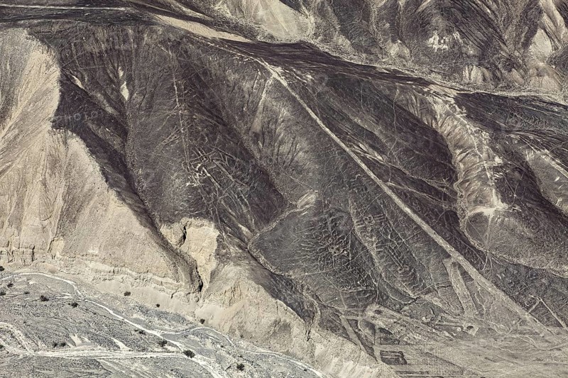 Aerial view of the Nazca Lines in Peru with clear geoglyphs on sandy hills, the geoglyphs and images in the desert near Nasca and Palpa in Peru