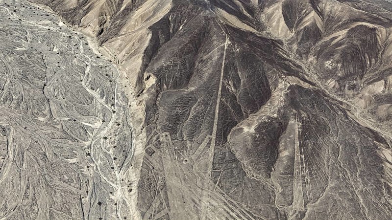 Aerial view of a desert landscape with complex line patterns and geoglyphs, the geoglyphs and images in the desert near Nasca and Palpa in Peru
