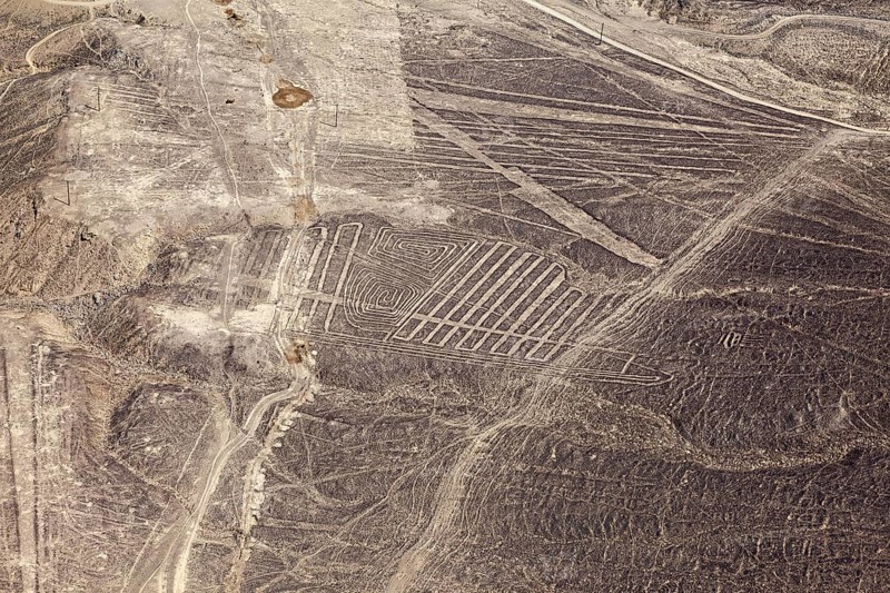 Nazca geoglyphs are visible on the dry surface landscape of the desert, the geoglyphs and drawings in the desert near Nasca and Palpa in Peru