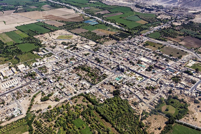 Aerial view of a city surrounded by agricultural land and a highly visible road network, The city of Nasca in Peru