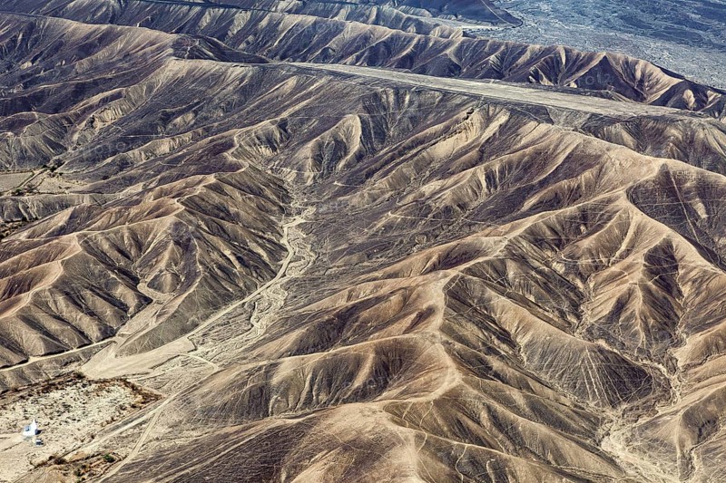 Barren range of hills with erosion-shaped structures in a dry environment, the desert landscape near Nasca in Peru