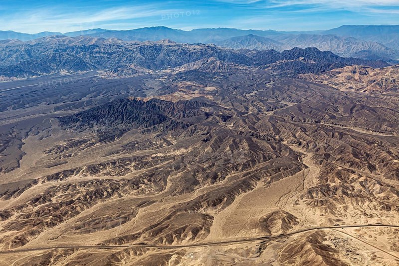 Barren mountainous desert area with characteristic hills, taken from above, The desert landscape near Nasca in Peru