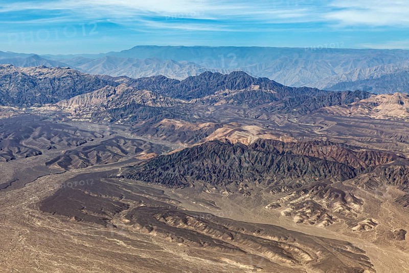 Hilly mountain landscape in a barren desert from a bird's eye view, The desert landscape near Nasca in Peru
