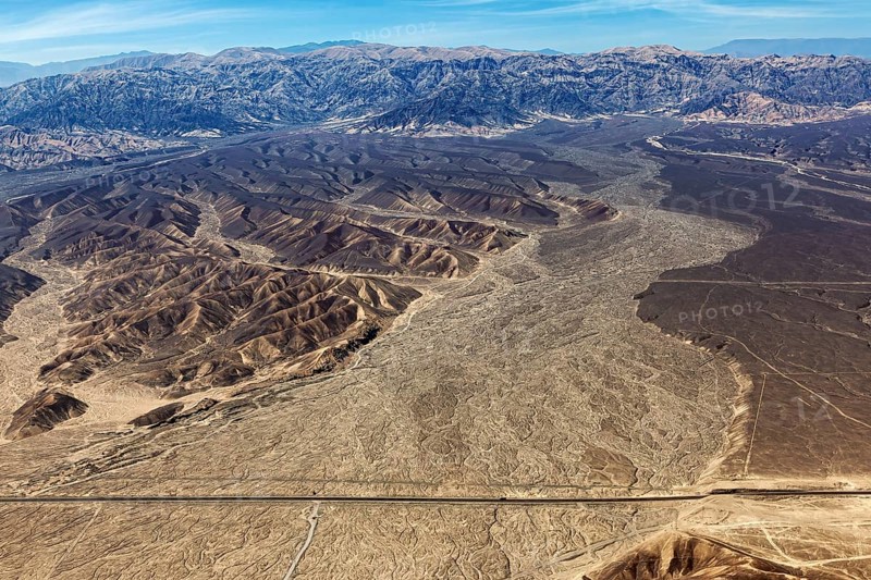 View of vast desert plains and mountain ranges from the air, The desert landscape near Nasca in Peru