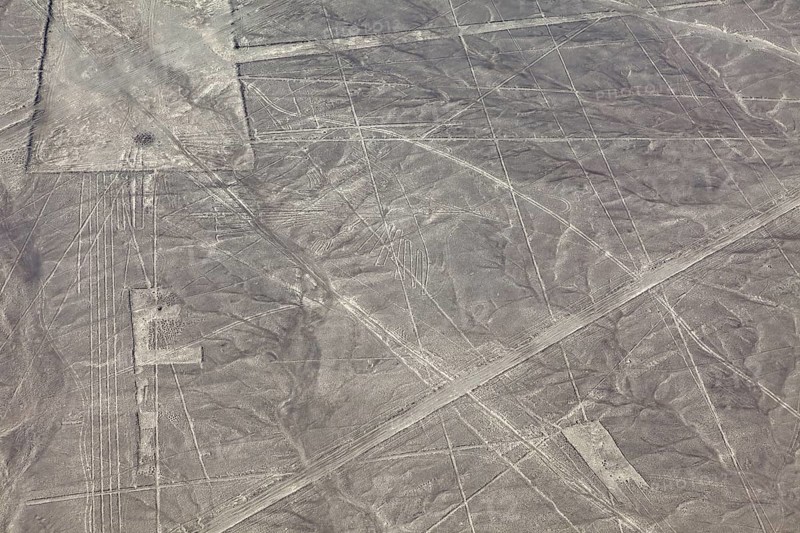 Nazca lines in a vast desert area with geometric patterns seen from the air, The geoglyphs and drawings in the desert near Nasca and Palpa in Peru