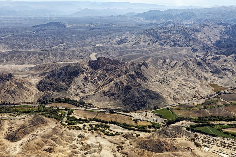 Landscape with mountains and green agricultural areas in the valley, The desert landscape near Nasca in Peru
