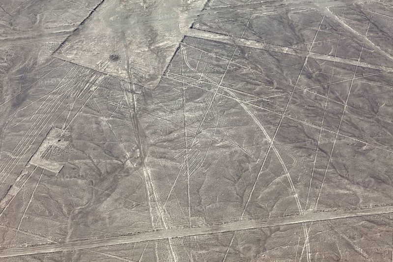 Aerial view of geometric figures in a dry desert landscape known as the Nazca Lines, the geoglyphs and drawings in the desert near Nasca and Palpa in Peru