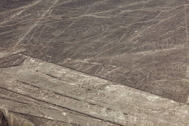 Nazca lines visible from the air with geometric shapes on barren desert soil, the geoglyphs and drawings in the desert near Nasca and Palpa in Peru