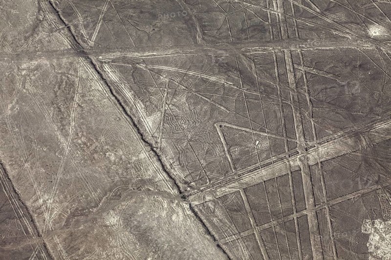 Aerial view of geometric lines on a barren desert landscape, the geoglyphs and images in the desert near Nasca and Palpa in Peru