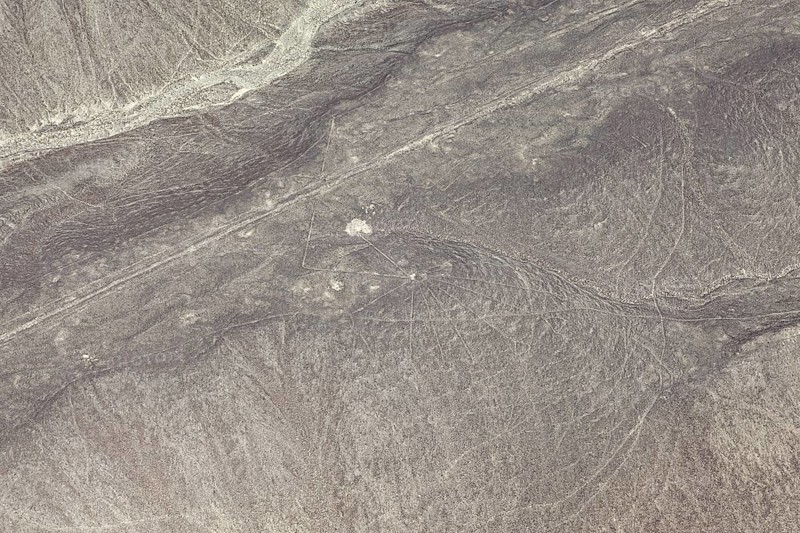 Aerial view of line patterns in a dry, sandy desert landscape, the geoglyphs and images in the desert near Nasca and Palpa in Peru