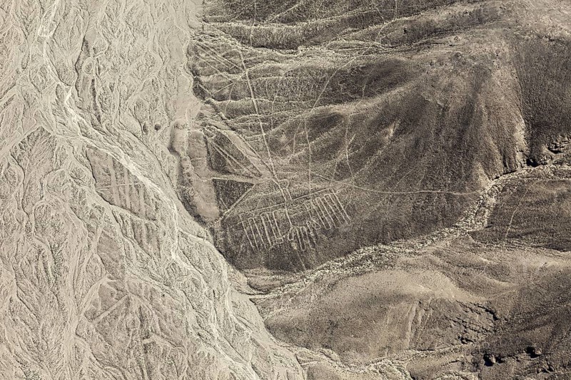 Impressive lines and shapes stretch across the barren mountain flank, the geoglyphs and paintings in the desert near Nasca and Palpa in Peru