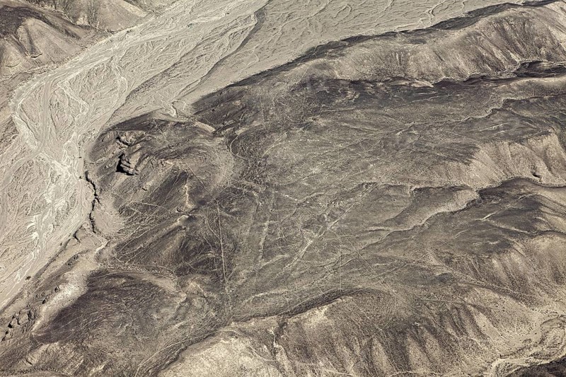 Dry desert with puzzling lines that cover the mountain and form geometric figures, the geoglyphs and drawings in the desert near Nasca and Palpa in Peru