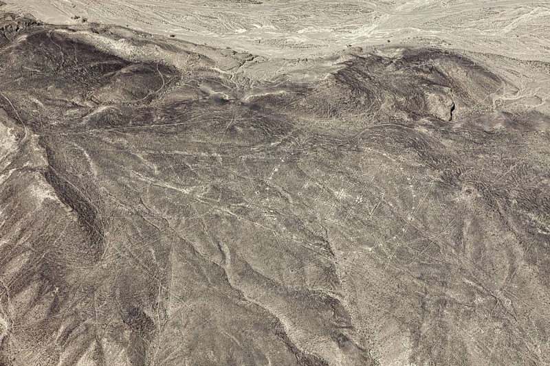 View of barren desert landscape with visible ancient line patterns, geoglyphs and drawings in the desert near Nasca and Palpa in Peru