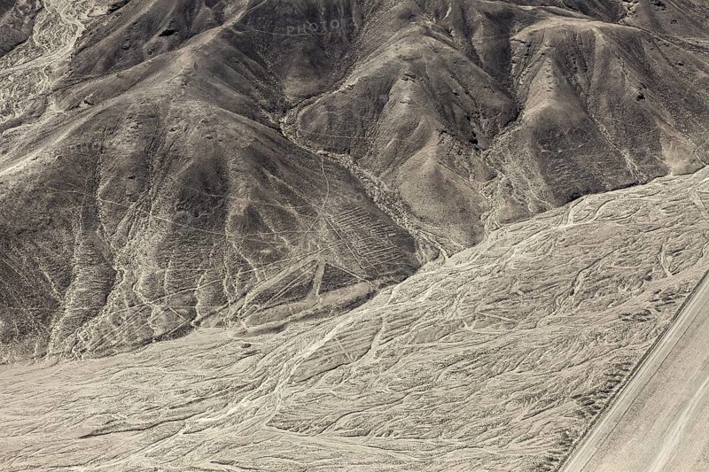 Hilly desert area with interlocking patterns and lines, the geoglyphs and drawings in the desert near Nasca and Palpa in Peru