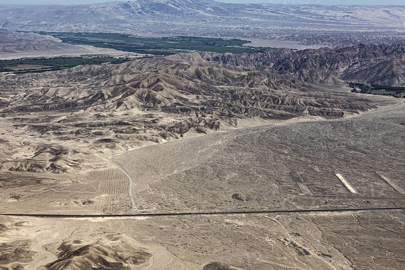 Wide desert-like landscape with mountains and valleys up to the horizon, the desert landscape near Nasca in Peru