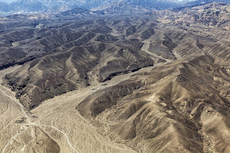 Barren mountain landscape with deep valleys and gentle elevations, the desert landscape near Nasca in Peru