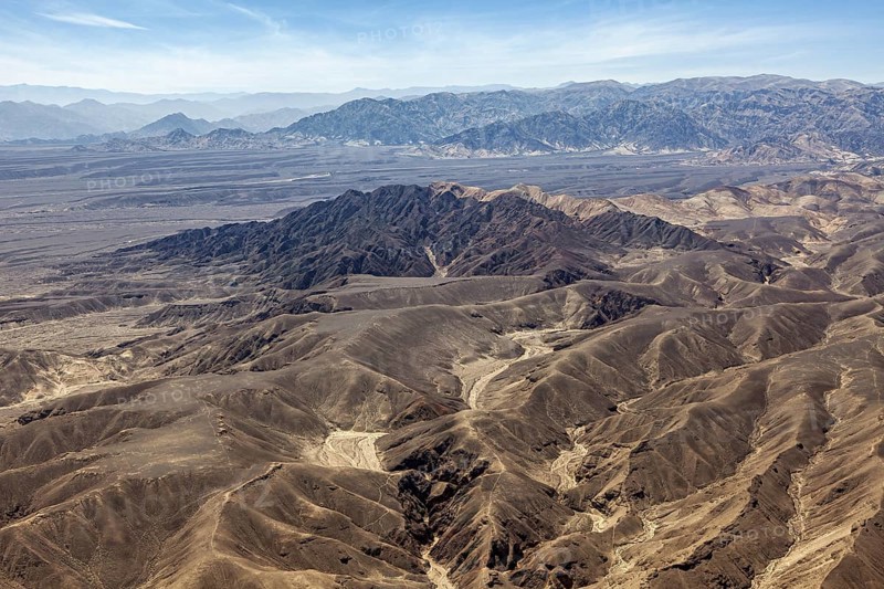 Breathtaking panorama of dry mountains in the desert under blue sky, the desert landscape near Nasca in Peru