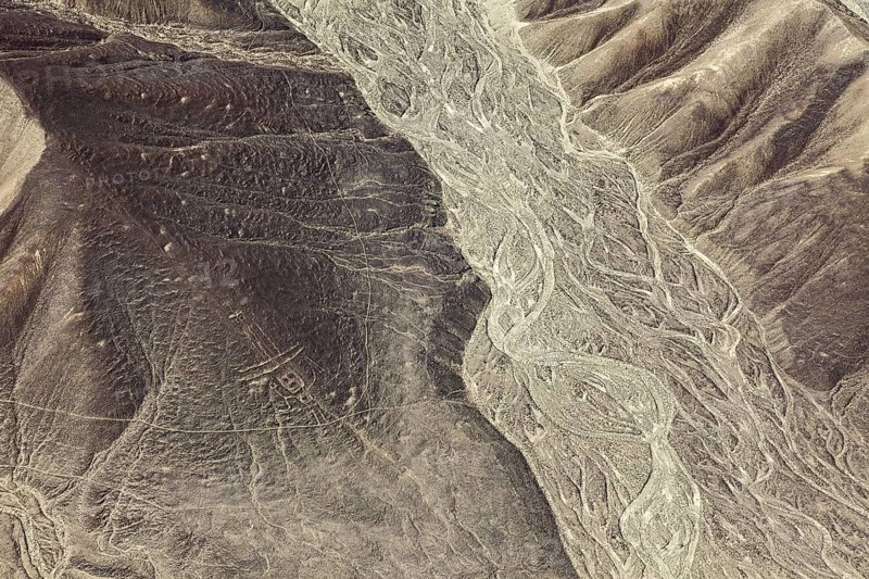 Barren desert hills with clear line formations from the air, the geoglyphs and images in the desert near Nasca and Palpa in Peru