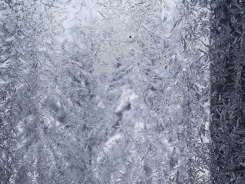 Close-up of a window with frozen ice forming intricate patterns, Frankenwald nature park Park