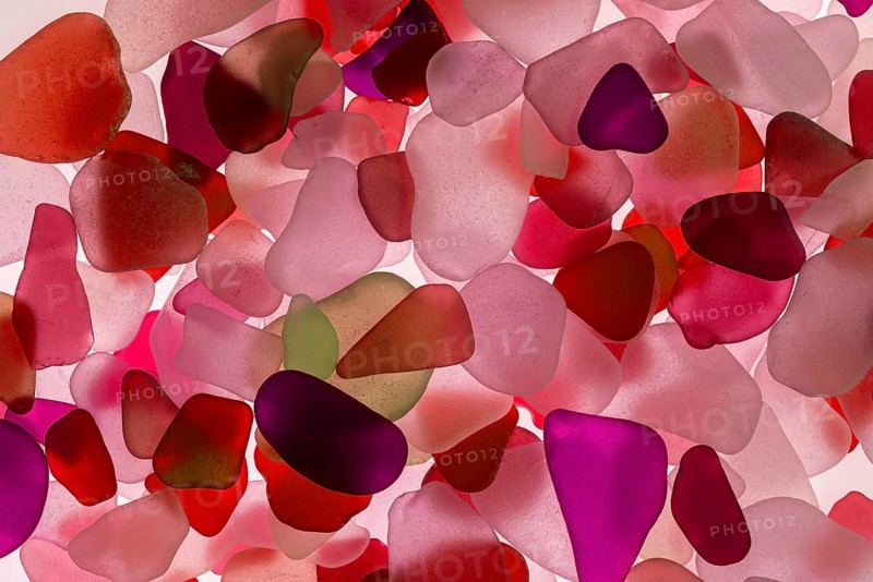 Red broken glass cut by the sea, sea glass, sea glass, beach glass from the North Sea