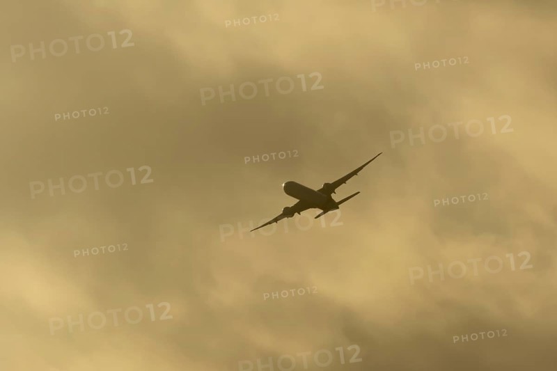 Commercial passenger airliner jet aircraft in flight at sunset at London Stansted airport, Essex, England, United Kingdom