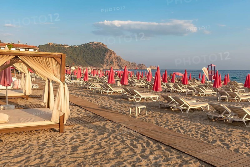 Alanya, Turkey. July 9th 2024 Sunbeds and pink sunshades on Cleopatra Beach in the Turkish holiday resort town of Alanya on the Mediterranean coast of Turkey, the Turkish Riviera