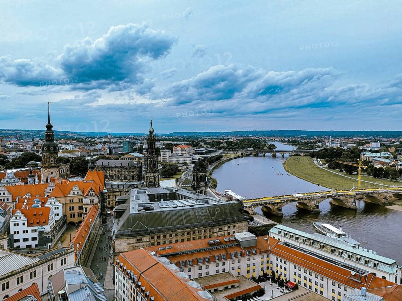 Panoramic view of Dresden with river and historic architecture under dramatic sky, Dresden