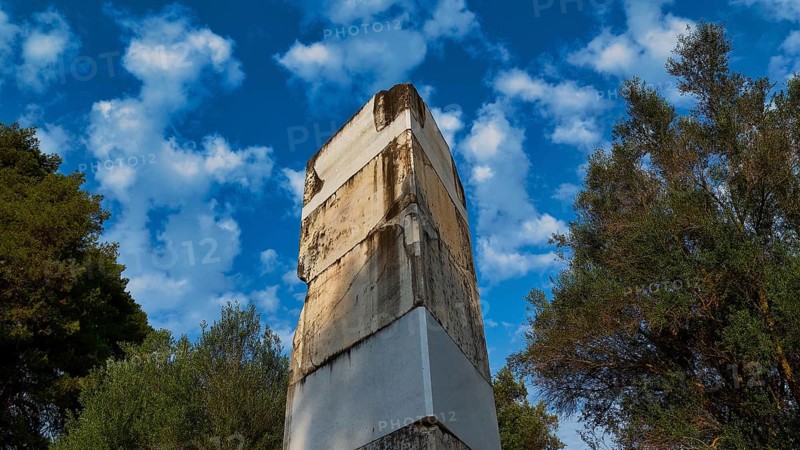 Ancient wall against cloudy sky and surrounded by trees, Archaeological Site, Ancient Olympia, Olympia, Peloponnese, Greece