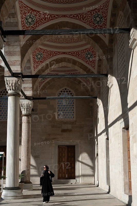 Istanbul, Turkey. January 3rd 2025. Muslim woman inside the ornate courtyard and newly restored Yeni Camii or New Mosque in the Eminonu district of Fatih, Istanbul, Turkey
