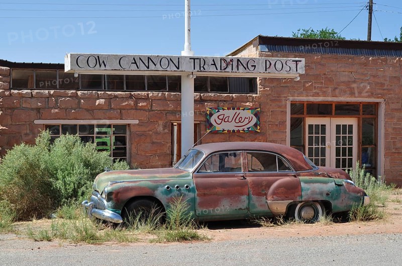 Abandoned trading post with old car and vegetation in the foreground, Monument Valley, Navajo Tribal Park, Navajo Nation Reservation, Utah, Arizona, USA
