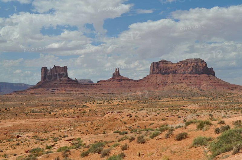 Impressive rock formations rise in a sunny desert landscape, Monument Valley, Navajo Tribal Park, Navajo Nation Reservation, Utah, Arizona, USA