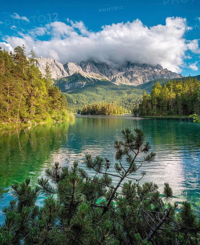 View over Lake Eibsee lake, the Wetterstein Mountains with the Zugspitze in the background, clouds moving across the peaks, Grainau, Garmisch-Partenkirchen, Bavaria, Germany
