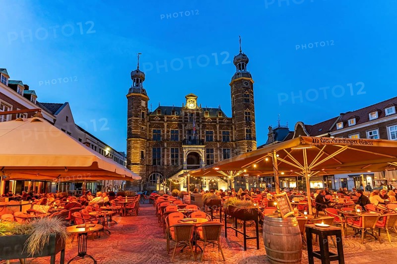 Restaurant and the historic town hall on the market in Venlo at dusk, the Netherlands