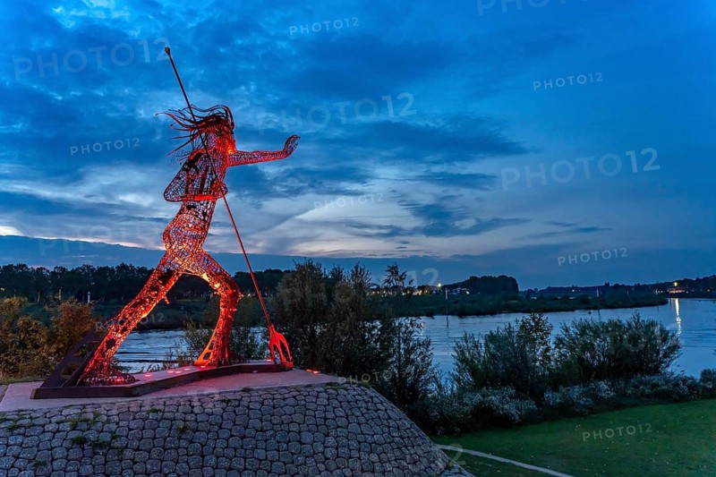 Peaceful Warrior Vreedzame Krijger sculpture on the Maas at dusk, Venlo, the Netherlands