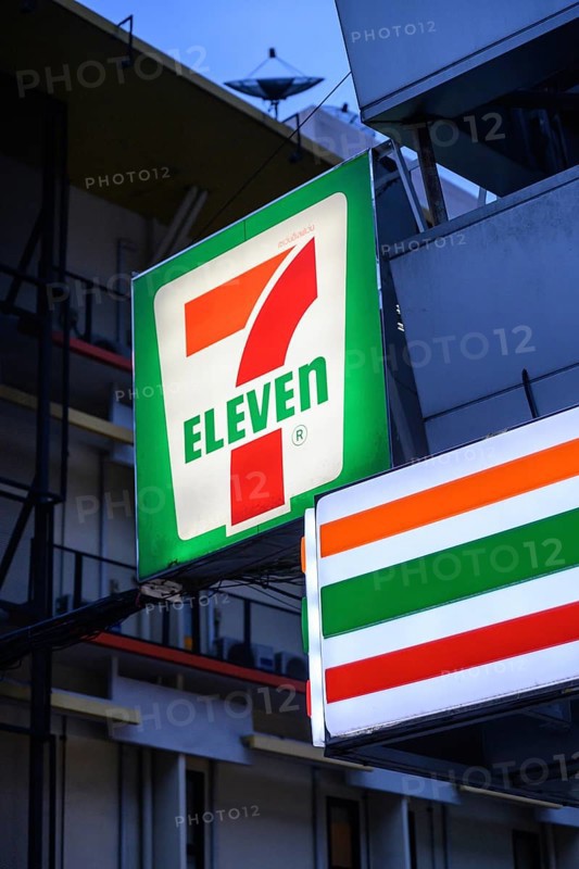 7 Eleven shop front sign and logo outside the popular convenience shop and supermarket in central Bangkok, Thailand