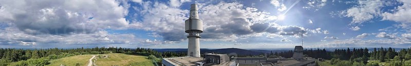 Panoramic view of the Schneeberg with the Backöfele, a high tower under a sunny sky full of clouds, Franconian mountain trail, hiking in the Fichtelgebirge nature park Park