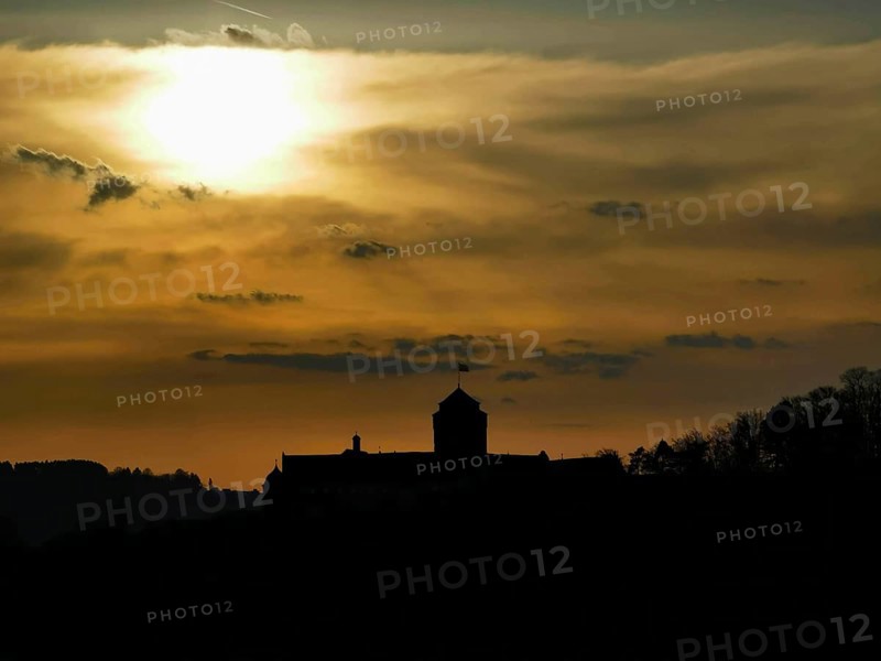 Silhouette of Rosenberg Fortress in Kronach in front of dramatic sunset sky, Frankenwald nature park Park