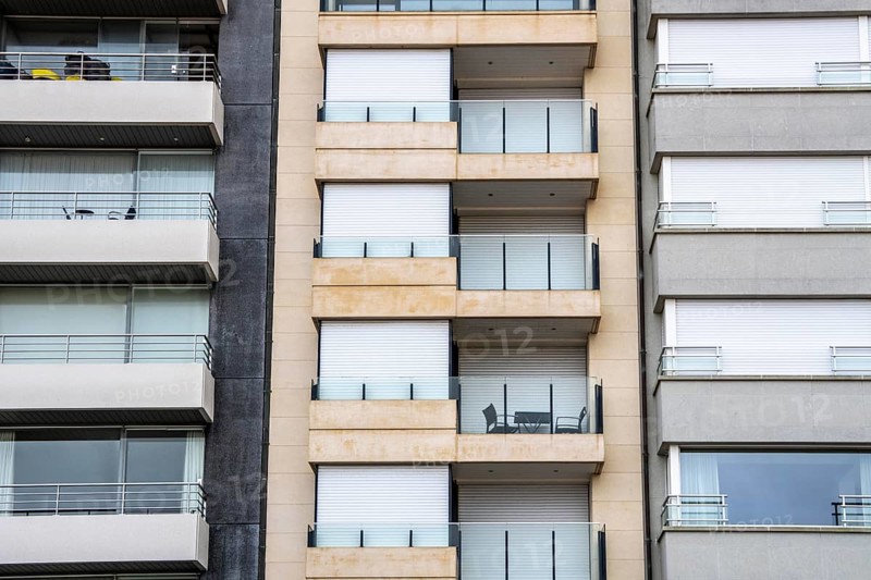 Facades of residential buildings on Zeedijk-Knokke, beach promenade in Knokke-Heist, largely uninhabited in winter, on the North Sea beach, dreary winter day, mostly apartment buildings with rental or condominiums, high-rise buildings on the street, Belgium