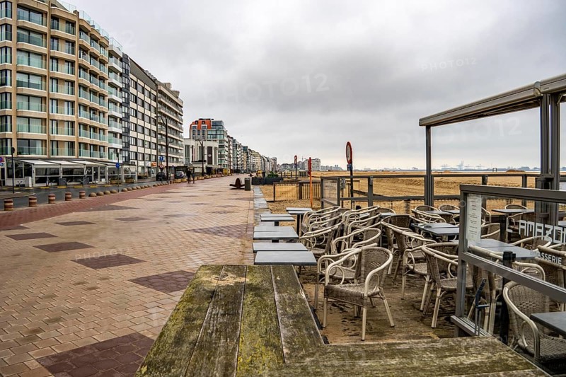 Winter break, closed terraces of catering establishments on Zeedijk-Knokke, beach promenade in Knokke-Heist, on the North Sea beach, dreary winter day, mostly apartment buildings with rental or condominiums, high-rise buildings on the street, Belgium