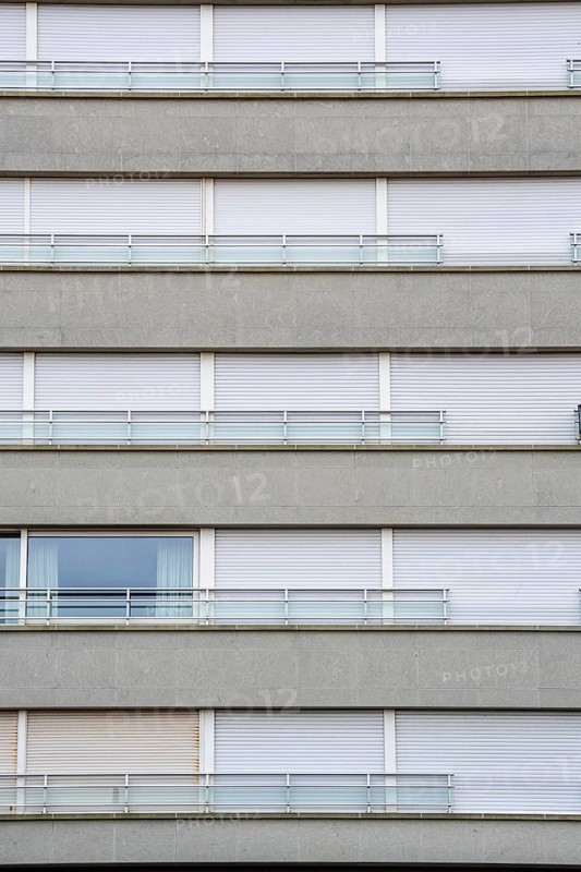 Facades of residential buildings on Zeedijk-Knokke, beach promenade in Knokke-Heist, largely uninhabited in winter, on the North Sea beach, dreary winter day, mostly apartment buildings with rental or condominiums, high-rise buildings on the street, Belgium