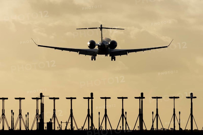 Gulfstream executive business jet aircraft in flight on approach to land at sunset at London Stansted airport, Essex, England, United Kingdom