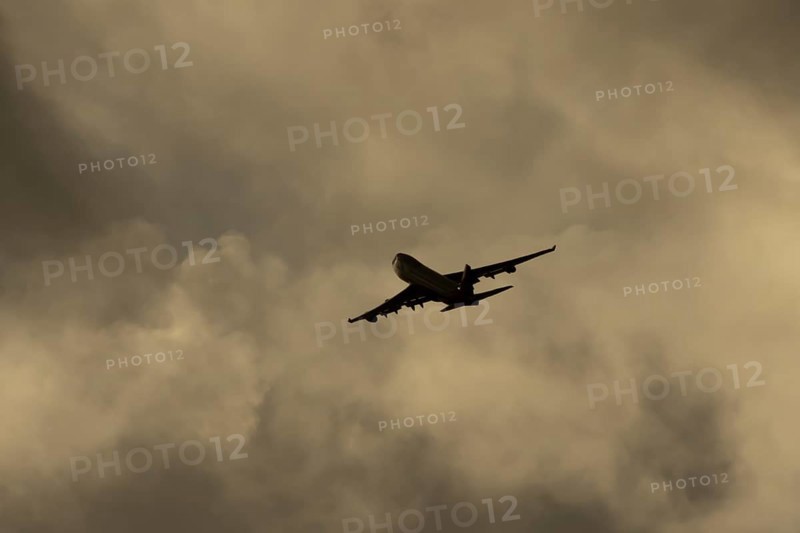 Boeing 747-400 jumbo jet LX-TCV commercial aircraft of Cargolux cargo in flight silhouette at sunset at London Stansted airport, Essex, England, United Kingdom