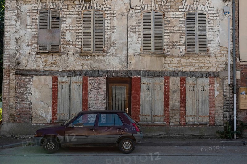 A popular old French car parked outside a typical rural French house in a countryside village in the Burgundy region of France