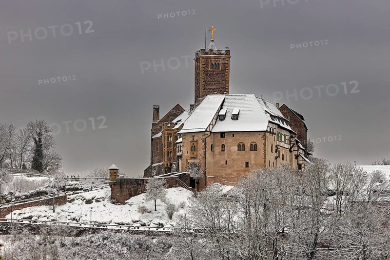 Castle in snow under cloudy sky, no vegetation visible in the foreground, The Wartburg near Eisenach in Thuringia