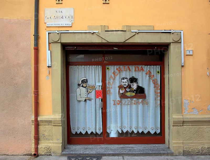 Italy, village of Brescello, advertisement for Pizzeria Pasquale, with a picture of Don Camillo and Peppone