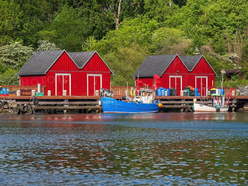 Small red huts and fishing boats in Boltenhagen fishing port, Baltic resort Boltenhagen, Mecklenburg-Western Pomerania, Germany